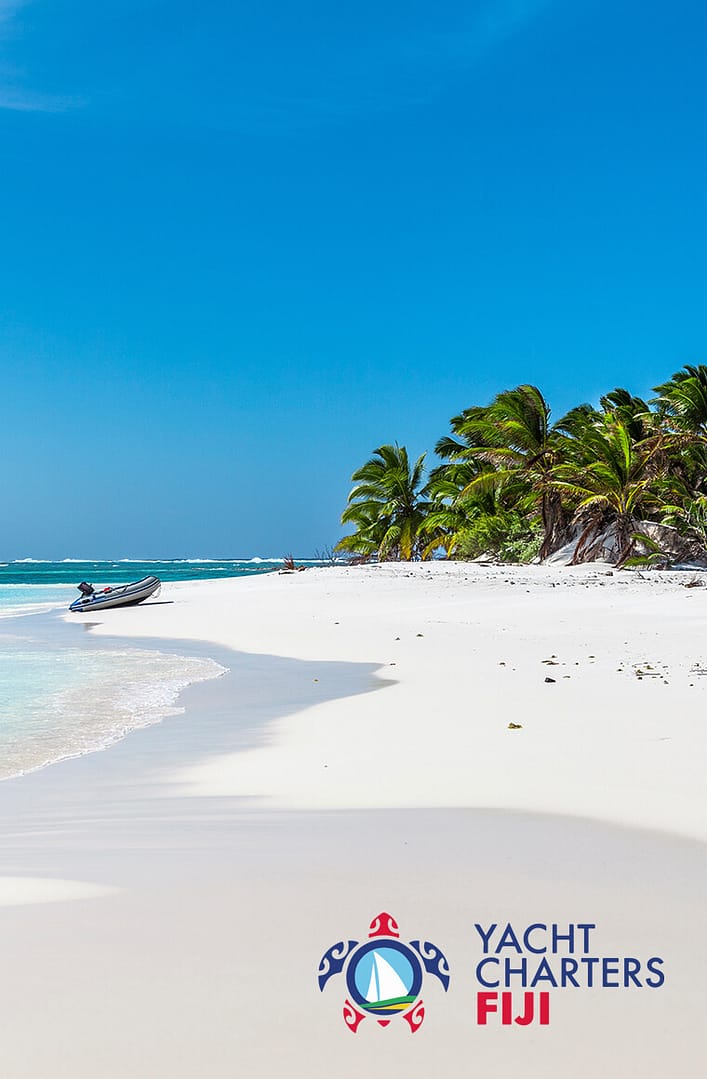 Sunny sandy beach and a boat at Fiji Islands